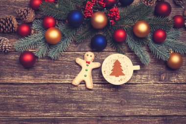 Noel ağacı şeklinde ahşap bir masa üzerinde sıcak cappuccino 