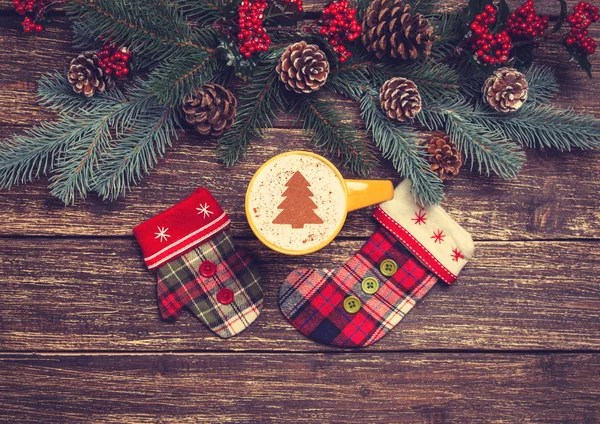 Hot cappuccino with christmas tree shape on a wooden table near — Stock Photo, Image
