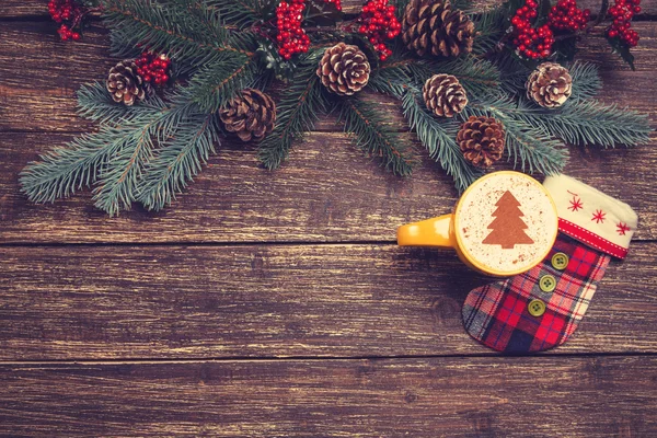 Cappuccino quente com forma de árvore de natal em uma mesa de madeira perto — Fotografia de Stock