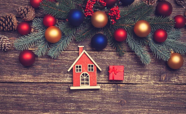 Home toy near pine branches and toys on a table — Stock Photo, Image