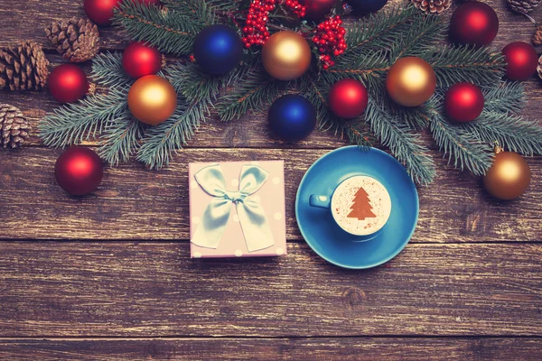 Hot cappuccino with christmas tree shape on a wooden table near — Stock Photo, Image