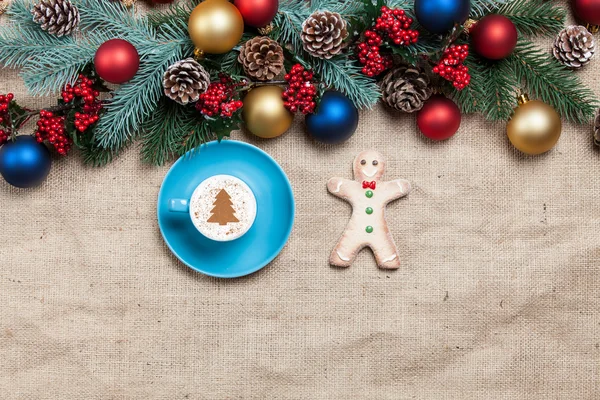 Hot cappuccino with christmas tree shape and cookie on a table n — Stock Photo, Image