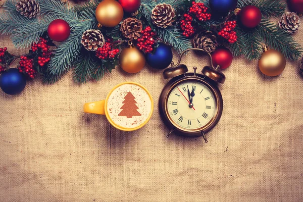 Hot cappuccino with christmas tree shape and alarm clock on a ta — Stock Photo, Image