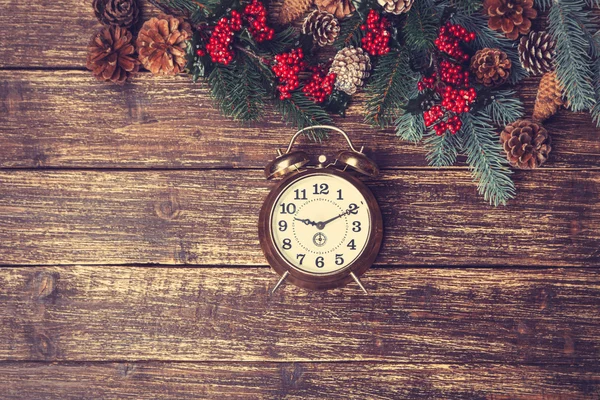 Vintage alarm clock with branch of pine — Stock Photo, Image