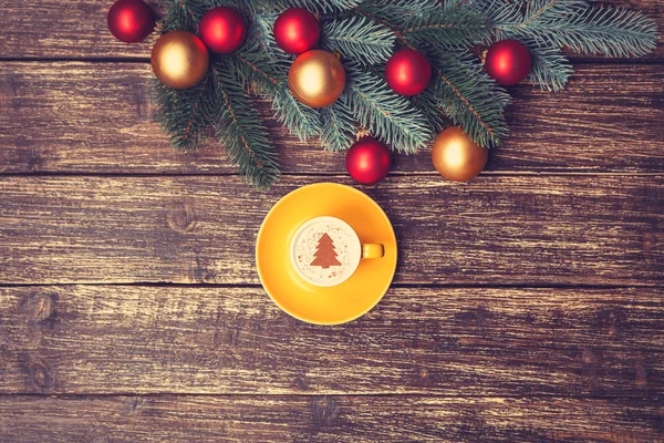 Cup of coffee with cream christmas tree on a table. — Stock Photo, Image