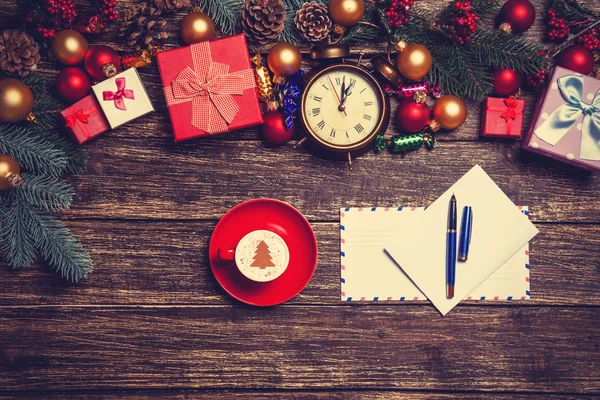 Letter and christmas gifts, coffee with alarm clocks and pine br — Stock Photo, Image