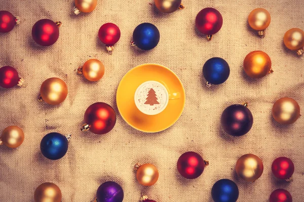 Cappuccino and with red, blue and gold christmas balls — Stock Photo, Image