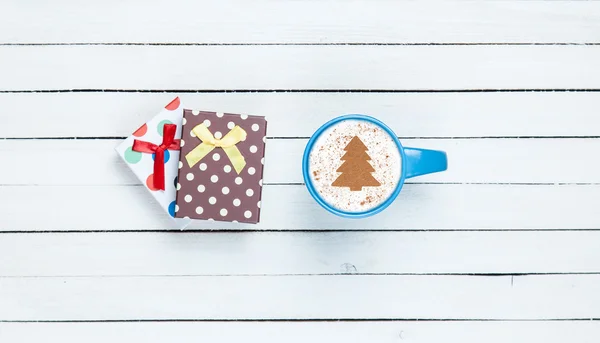 Luxe-geschenketui en cappuccino op witte houten tafel. — Stockfoto