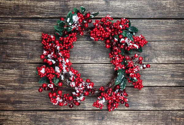 Holly christmas wreath on wooden table. — Stock Photo, Image