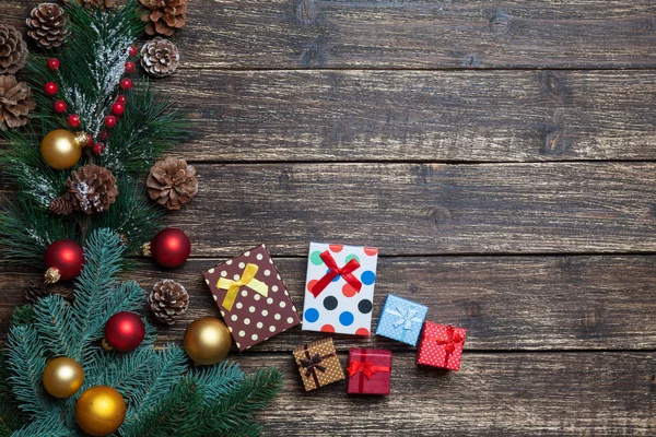 Pine branch and gift boxes on a wooden table. — Stock Photo, Image