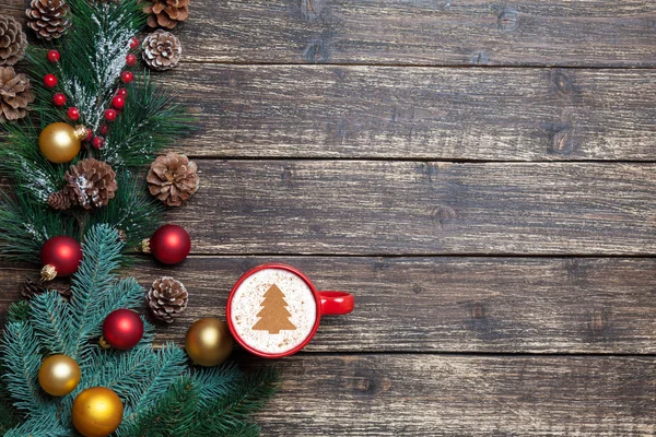 Cappuccino with christmas tree shape and pine branch on wooden t — Stock Photo, Image