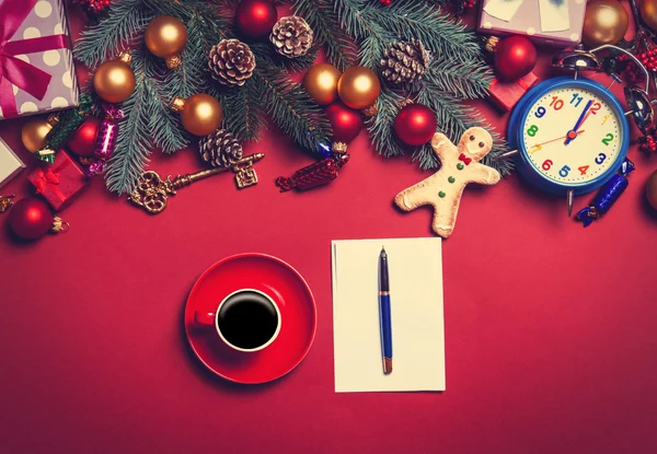 Coffee and letter with christmas gifts on red background. — Stock Photo, Image