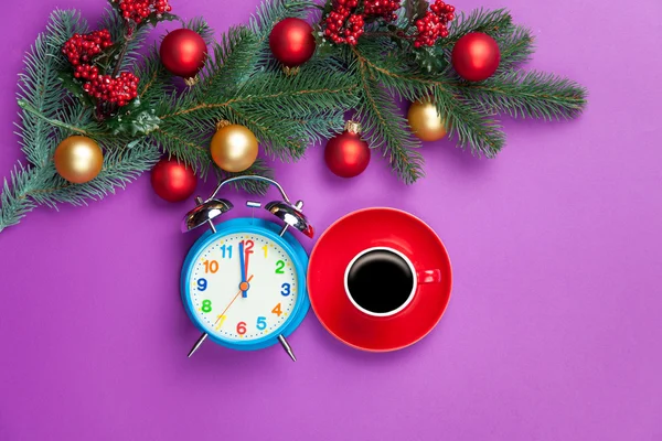 Hot coffee and pine branch with christmas toys on violet backgro — Stock Photo, Image