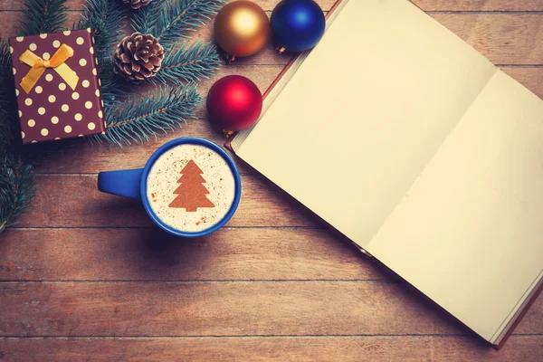 Cappuccino and opened book on wooden table near toys. — Stock Photo, Image