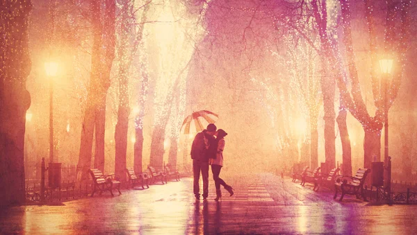 Couple with umbrella kissing at night alley. — Stock Photo, Image
