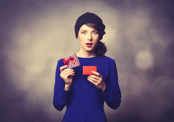 Women in blue dress with gift — Stock Photo, Image