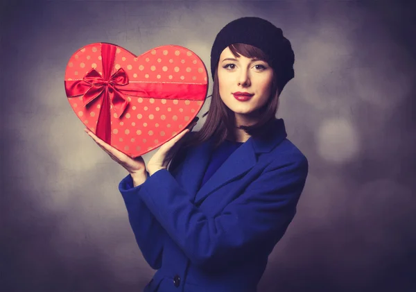 Women in blue dress with heart shape gift — Stock Photo, Image