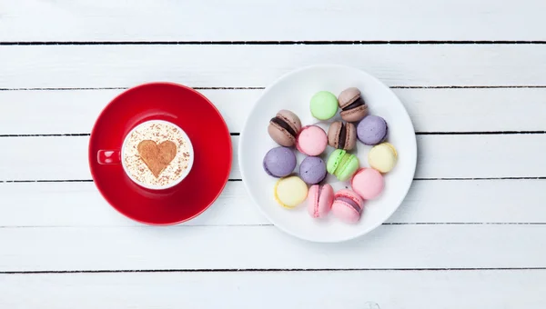 Cappuccino z symbol kształt serca i macaron — Zdjęcie stockowe