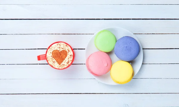 Cappuccino med hjärta form symbol och macaron — Stockfoto