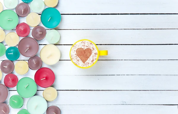 Cappuccino and candles on white background — Stock Photo, Image