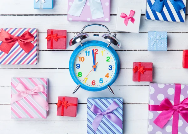 Gift boxes and alarm clock — Stock Photo, Image