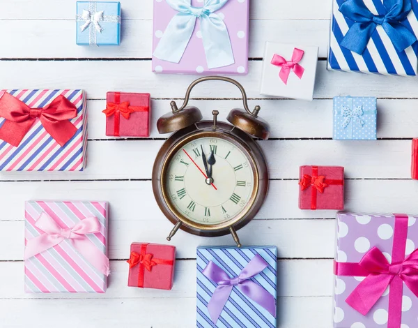 Gift boxes and alarm clock — Stock Photo, Image
