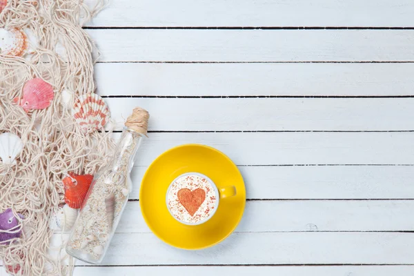 Tazza di Cappuccino e rete con bottiglia — Foto Stock