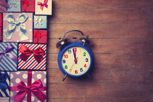 Gift boxes and alarm clock — Stock Photo, Image