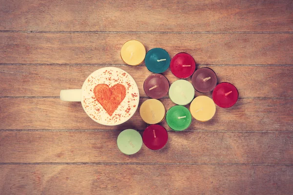 Cup and candles on a talbe — Stock Photo, Image