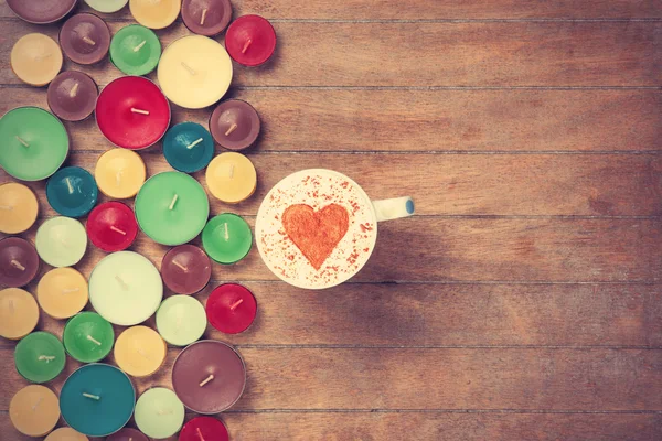 Cup and candles on a talbe — Stock Photo, Image