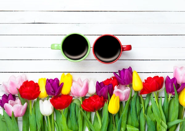 Two cups of coffee near tulips — Stock Photo, Image