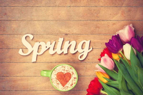 Cappuccino and word Spring near flowers — Stock Photo, Image