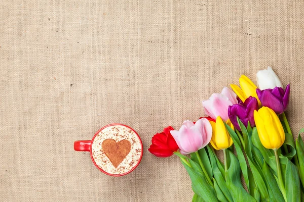 Tulips and cup of cuppuccino — Stock Photo, Image