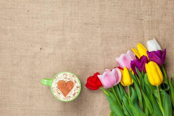 Tulips and cup of cuppuccino — Stock Photo, Image