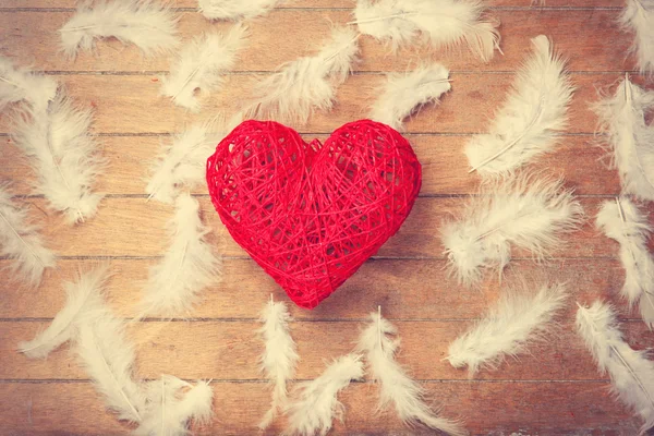 Toy heart shape and feathers — Stock Photo, Image