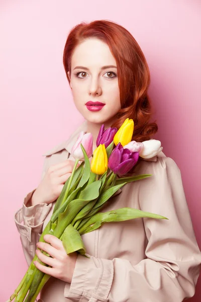 Beautiful redhead girl with flowers — Stock Photo, Image