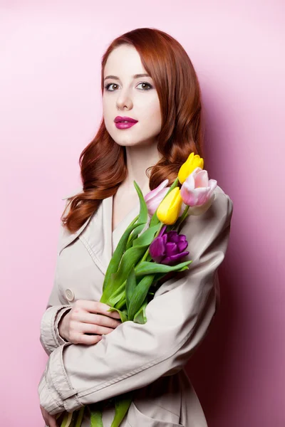 Beautiful redhead girl with flowers — Stock Photo, Image