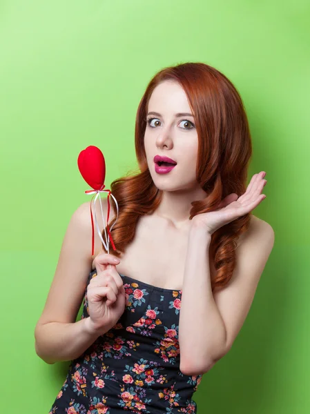 Beautiful redhead girl with flowers — Stock Photo, Image