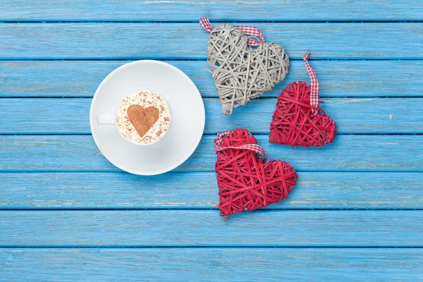 Cup of Cappuccino with heart shape symbol and toys — Stock Photo, Image