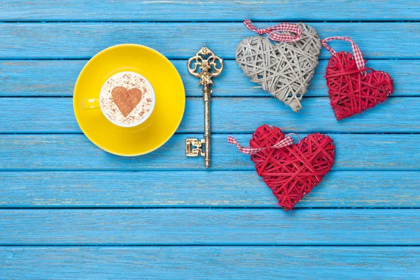 Copa de Cappuccino con símbolo de forma de corazón, llave y juguetes — Foto de Stock