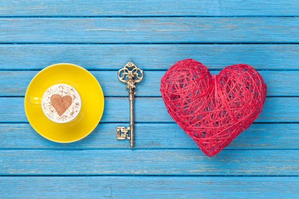 Cup of Cappuccino with heart shape symbol, key and toy — Stock Photo, Image