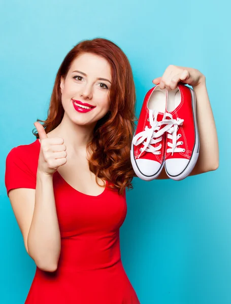 Улыбающаяся рыжая девушка в резиновых туфлях — стоковое фото