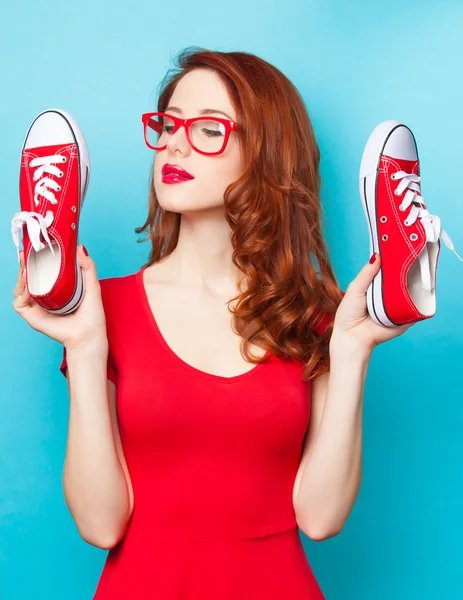 Girl in red dress with gumshoes — Stock Photo, Image