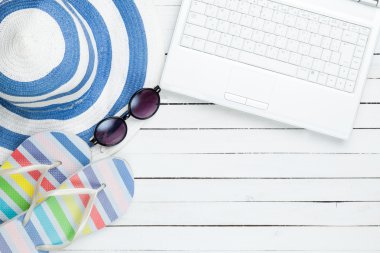 Beyaz bilgisayar ve flip flop ayakkabı elbise ile 