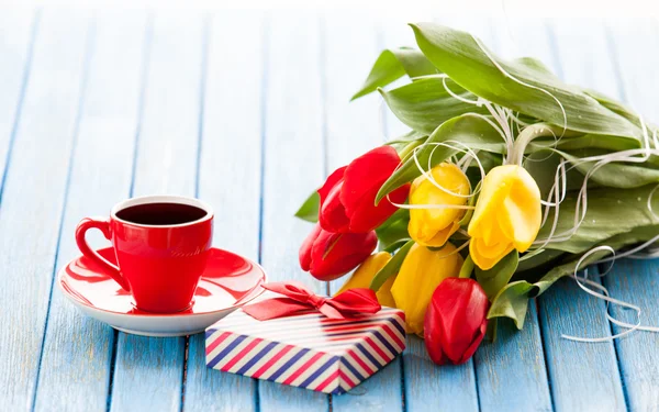 Cup en geschenk doos met boeket van tulpen — Stockfoto