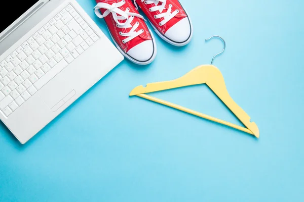 White computer and gumshoes with hanger — Stock Photo, Image