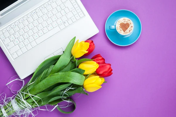 Cup of cappuccino with heart shape and computer — Stock Photo, Image