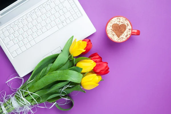 Cup of cappuccino with heart shape and computer — Stock Photo, Image