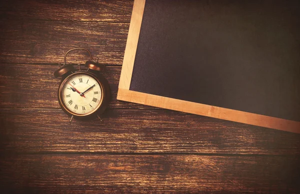 Retro alarm clock and blackboard — Stock Photo, Image