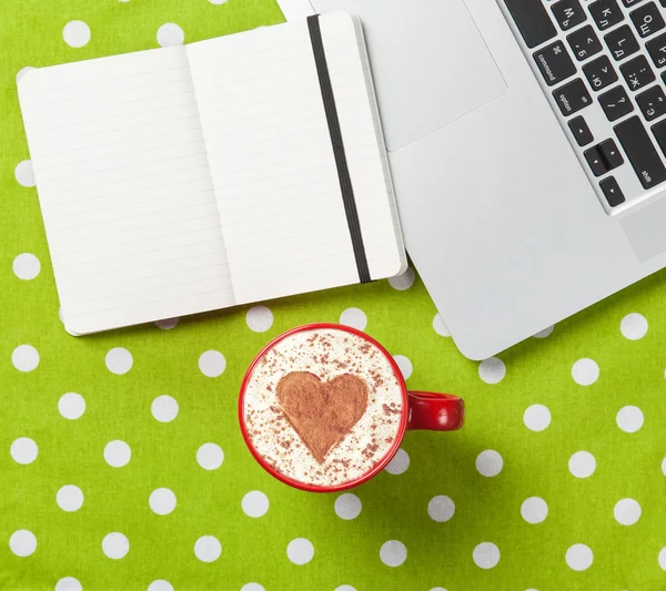 Cappuccino and notebook near laptop — Stock Photo, Image